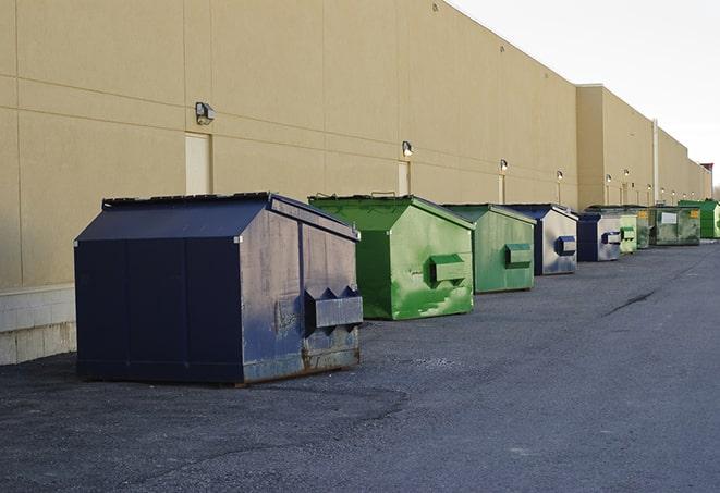 a stack of yellow construction dumpsters on a job site in Frankfort